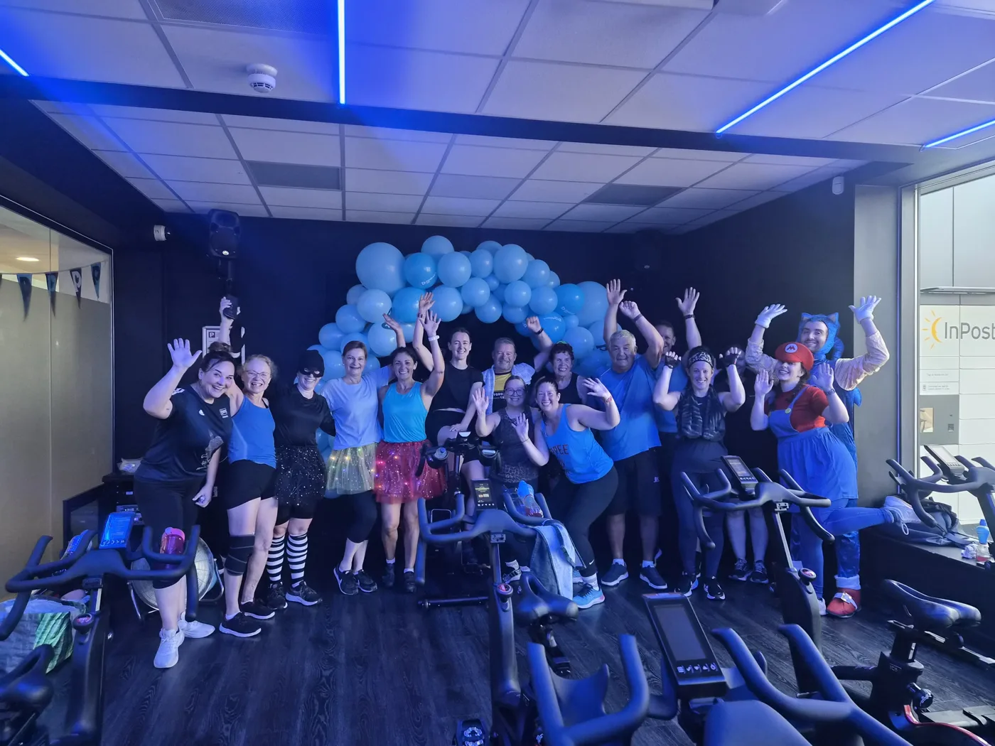Spinathon riders in fancy dress in the cycling studio at Fairfield Leisure